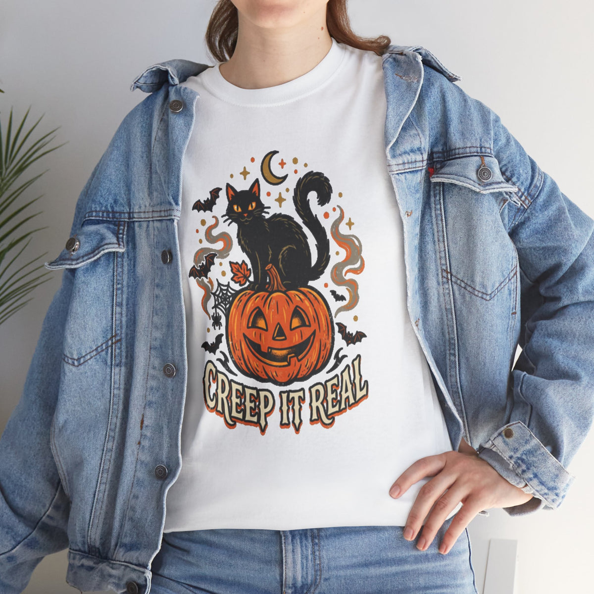 Keep spooky season stylish with this funny Creep It Real black cat t-shirt featuring a vintage jack-o'-lantern, bats, and retro Halloween vibes.